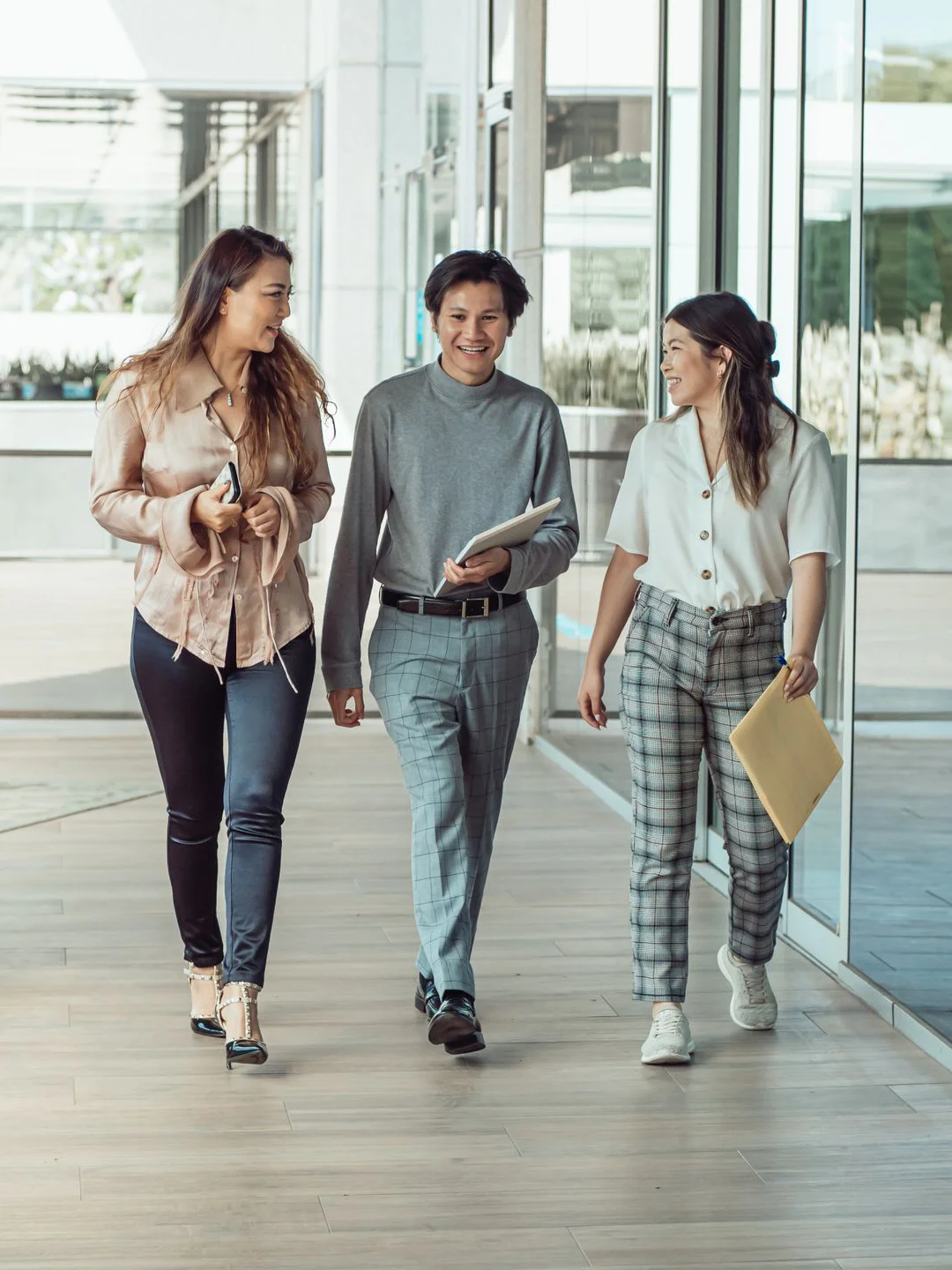 Three colleagues returning to office from an external meeting