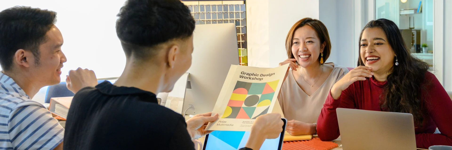 Four team members engaged in meeting